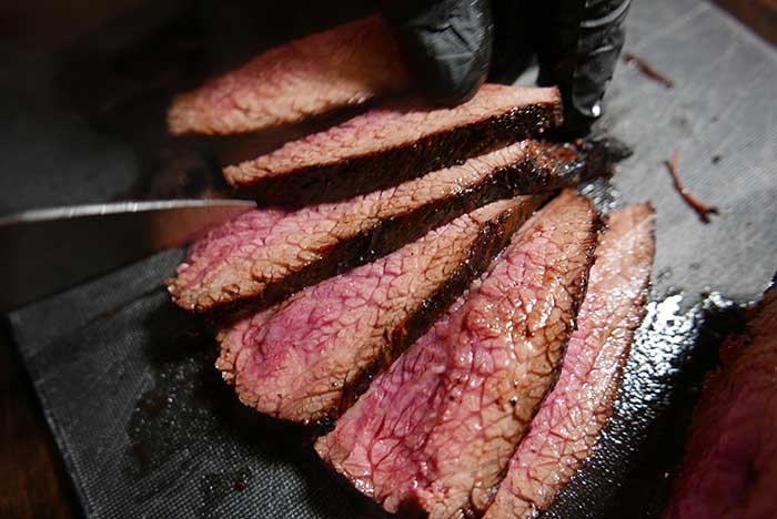 sliced beef tri tip steak on a cutting board