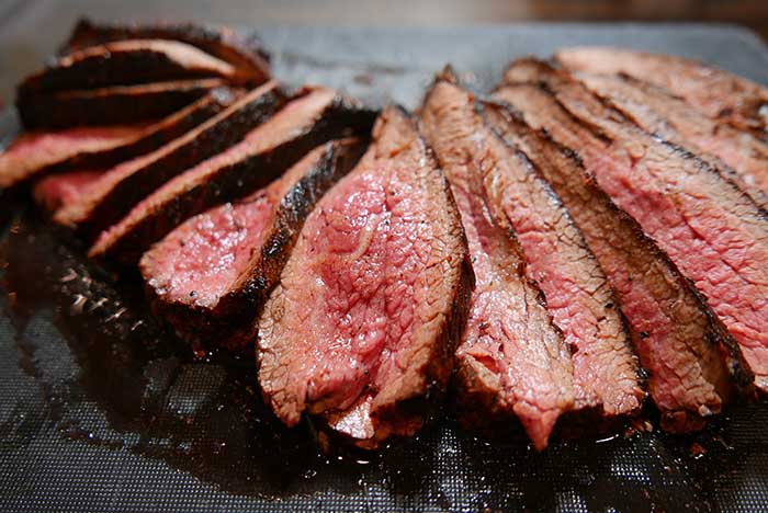 sliced beef tri tip steak on a cutting board