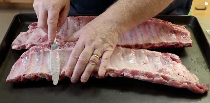 sliding blunt table knife under pork rib silver skin