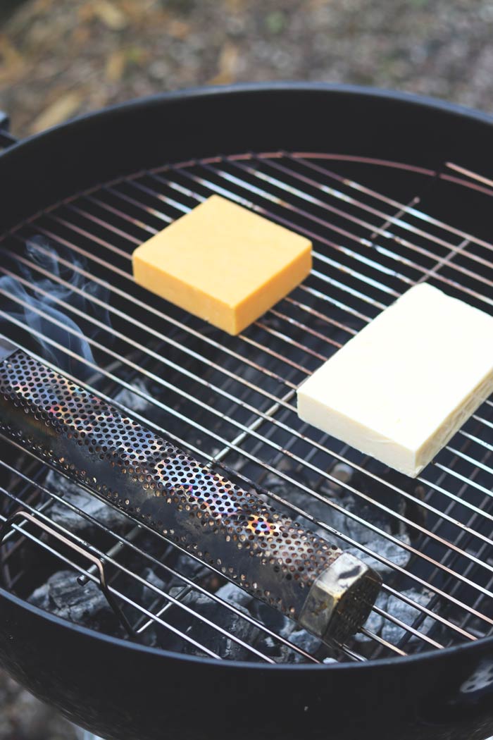 cheddar and red leicester cheese on charcoal grill grates with pellet smoker tube