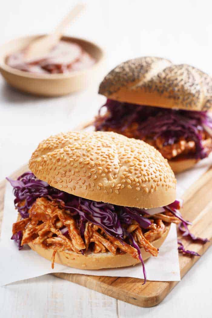 smoked bbq pulled chicken in bread bun and onion slaw