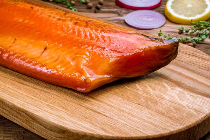 close up of cold smoked trout on chopping board