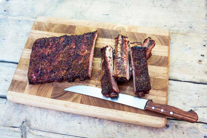 smoked ribs with rib and bark on chopping board