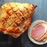 smoked whole sliced ham on rustick background