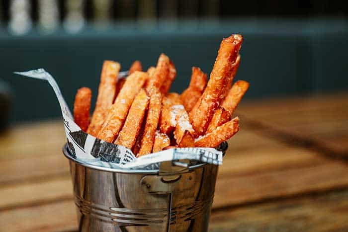 sweet potato fries with sea salt in a metal bucket